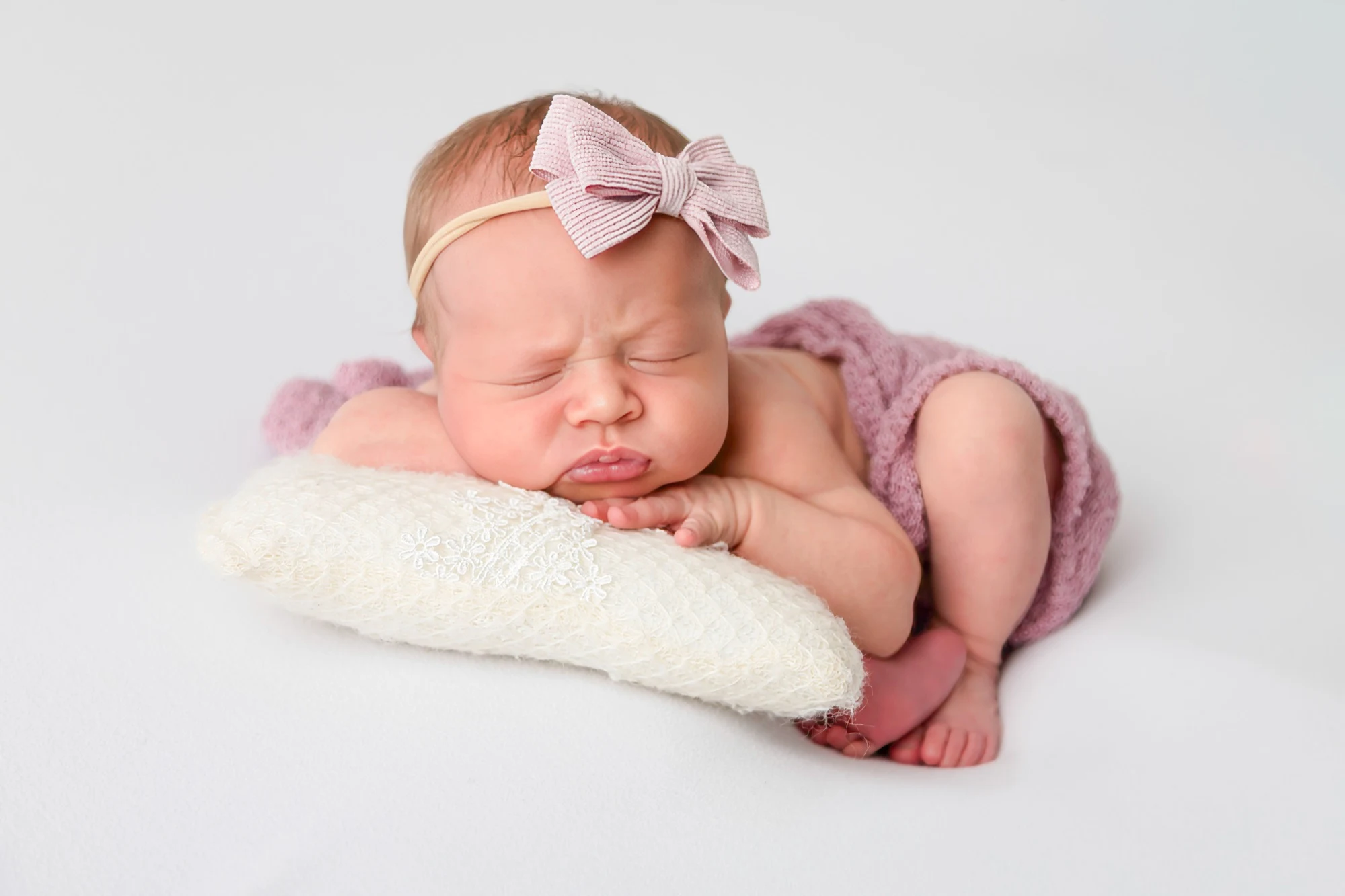 Newborn wrapped in cream